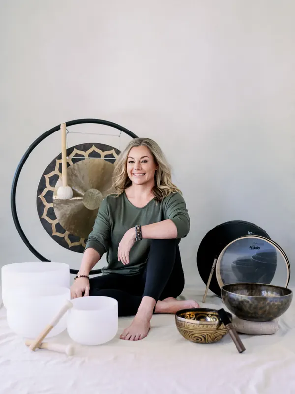 Penny Bailey, DrPH, with gong, crystal singing bowls, frame drum, and Tibetan bowls used in group sound journey sessions in Scottsdale and Phoenix Arizona